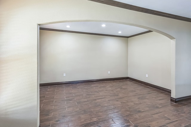 empty room featuring dark hardwood / wood-style floors and crown molding