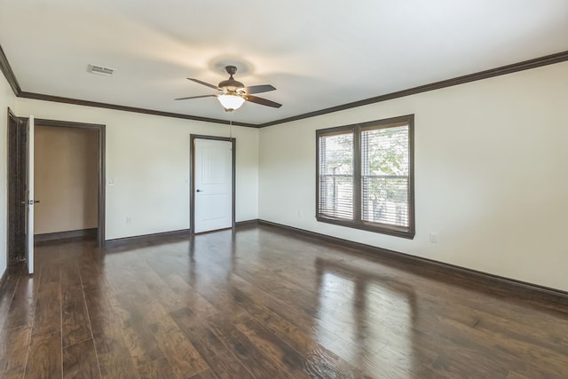 spare room featuring ceiling fan, ornamental molding, and dark wood-type flooring