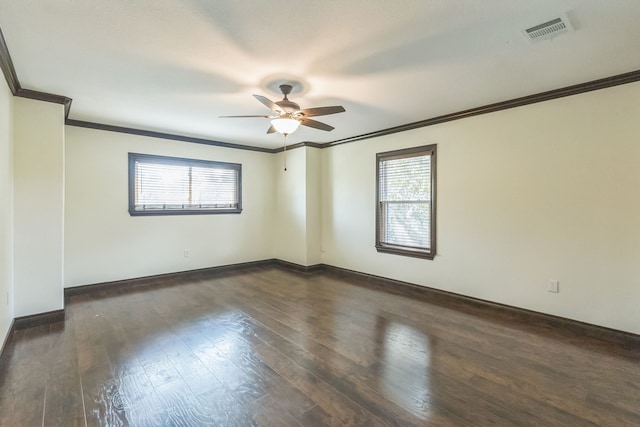 spare room with ceiling fan, plenty of natural light, dark hardwood / wood-style flooring, and crown molding