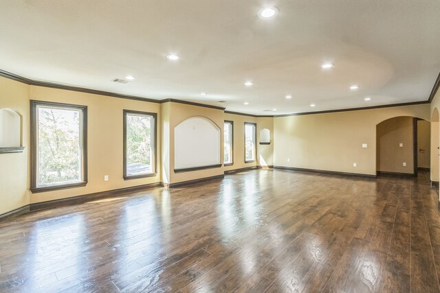 24578 Derry St, Hempstead, TX 77445 - unfurnished living room with crown molding, arched walkways, healthy amount of natural light, recessed lighting, and baseboards
