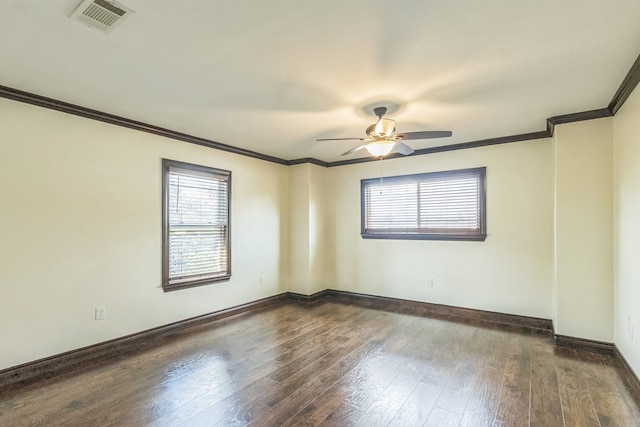 unfurnished room with ceiling fan, crown molding, and dark wood-type flooring