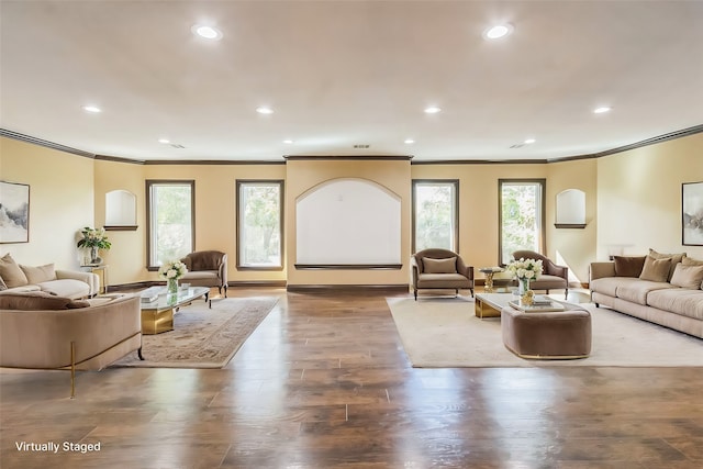 living room with a healthy amount of sunlight, crown molding, and hardwood / wood-style floors