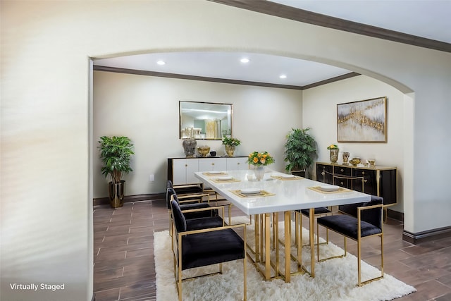 dining space with crown molding and dark hardwood / wood-style flooring