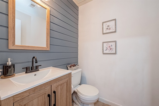 bathroom featuring toilet and vanity