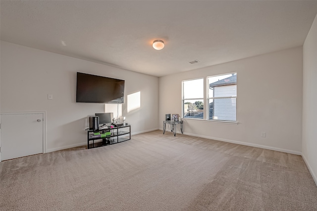 unfurnished living room with light colored carpet