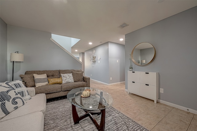 tiled living room with a skylight