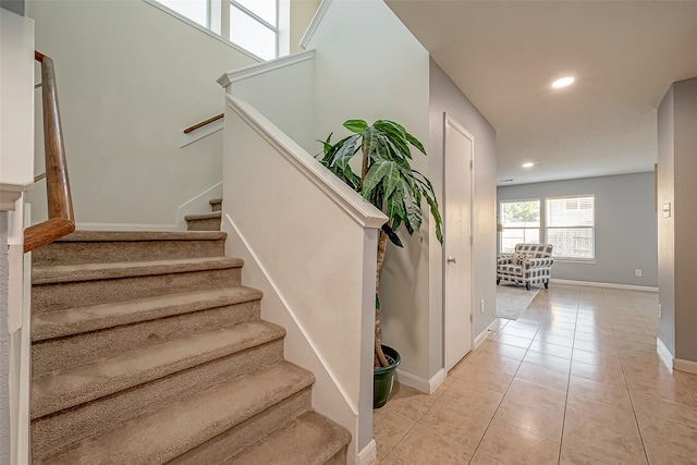 staircase featuring tile patterned floors