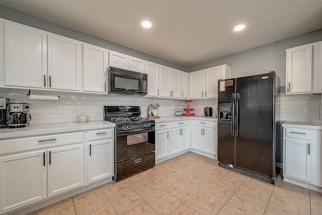 kitchen featuring decorative backsplash, white cabinetry, black appliances, and light tile patterned floors