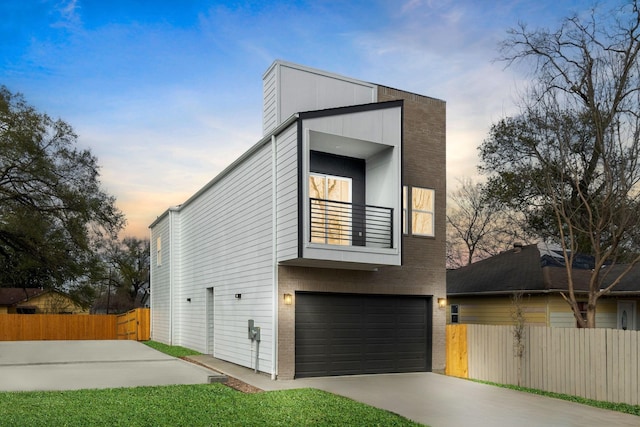 contemporary home with a balcony and a garage