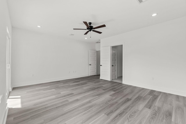 spare room featuring ceiling fan and light hardwood / wood-style flooring