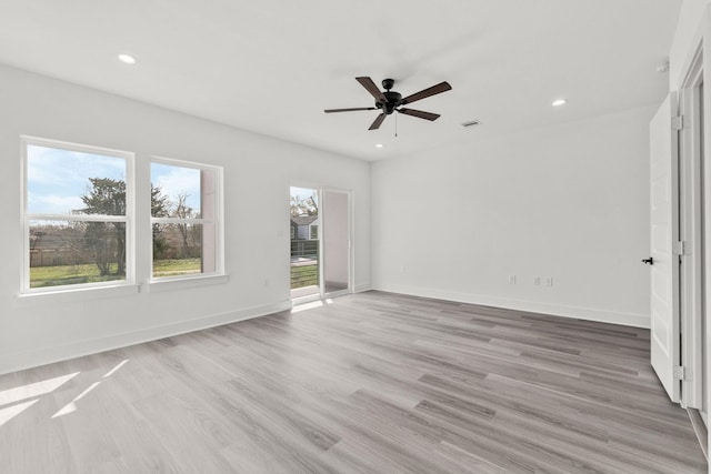 empty room featuring ceiling fan and light hardwood / wood-style flooring