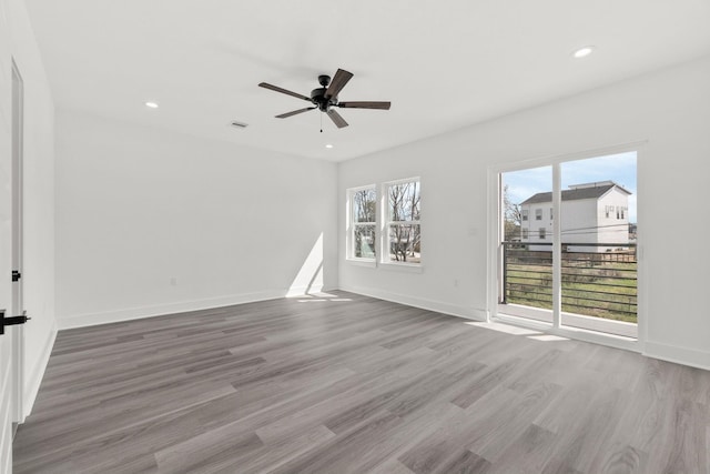 empty room with light wood-type flooring and ceiling fan