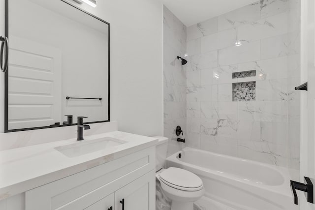 full bathroom with toilet, tiled shower / bath combo, and vanity