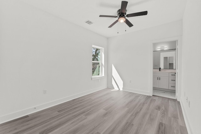 unfurnished bedroom with ceiling fan, connected bathroom, light hardwood / wood-style flooring, and sink