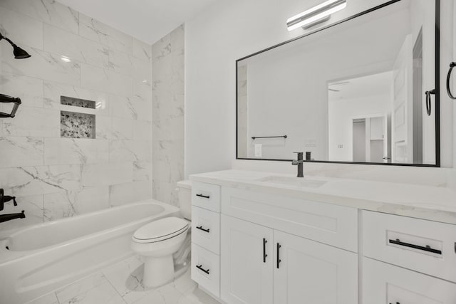 full bathroom featuring toilet, tiled shower / bath, and vanity