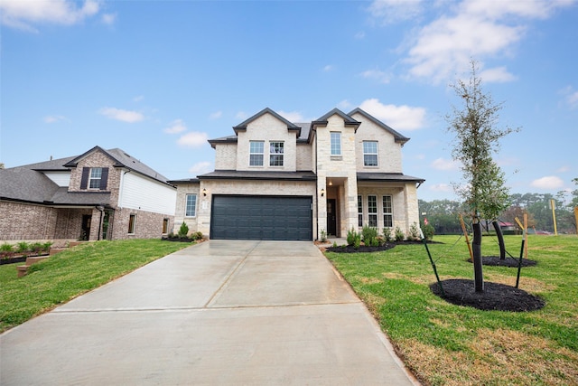 view of front of home with a garage and a front lawn