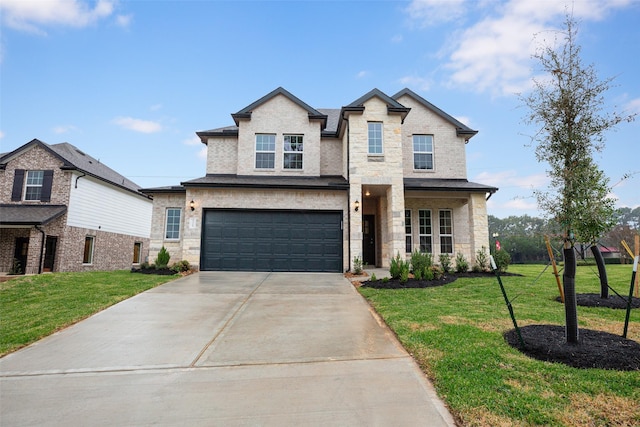 view of front of property with a garage and a front lawn