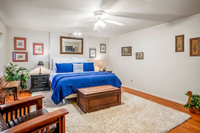 bedroom with ceiling fan and light wood-type flooring