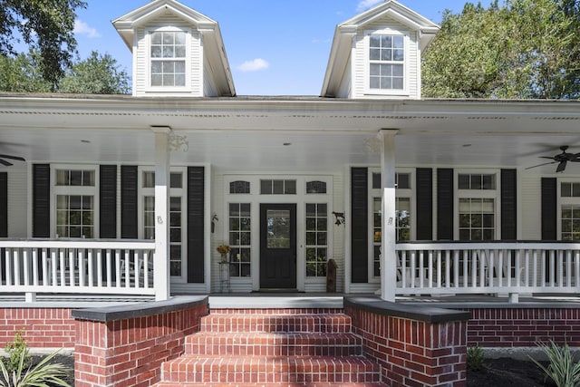 property entrance featuring ceiling fan and a porch