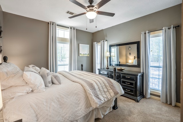 bedroom with light colored carpet and ceiling fan