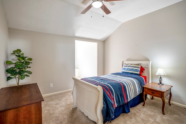 carpeted bedroom with vaulted ceiling and ceiling fan