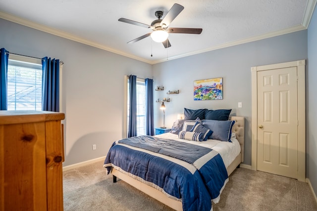 carpeted bedroom featuring ceiling fan and crown molding