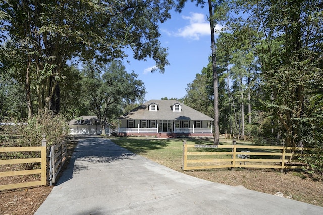 farmhouse with a front yard and covered porch