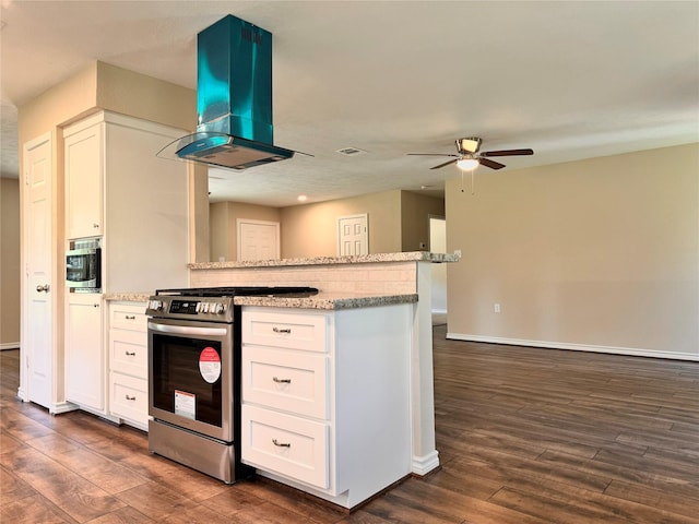 kitchen with white cabinets, island range hood, dark hardwood / wood-style floors, and stainless steel range oven