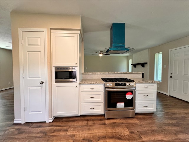 kitchen featuring light stone countertops, dark hardwood / wood-style flooring, stainless steel appliances, exhaust hood, and white cabinetry