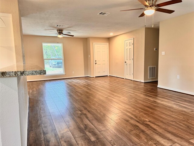 spare room featuring ceiling fan, dark hardwood / wood-style flooring, and a textured ceiling