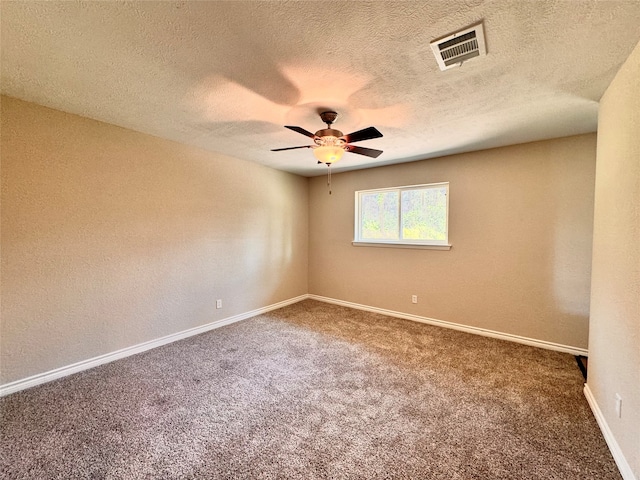 spare room featuring carpet flooring, ceiling fan, and a textured ceiling