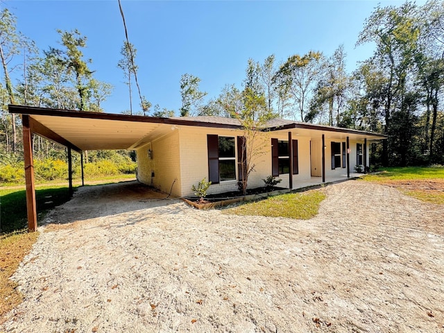 view of front of property with covered porch and a carport