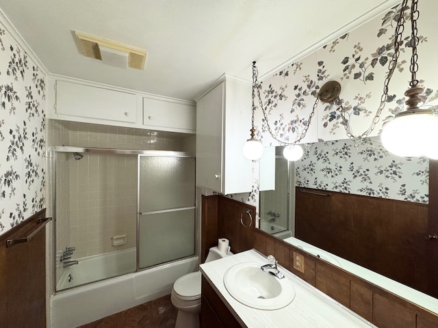 full bathroom featuring vanity, enclosed tub / shower combo, and toilet