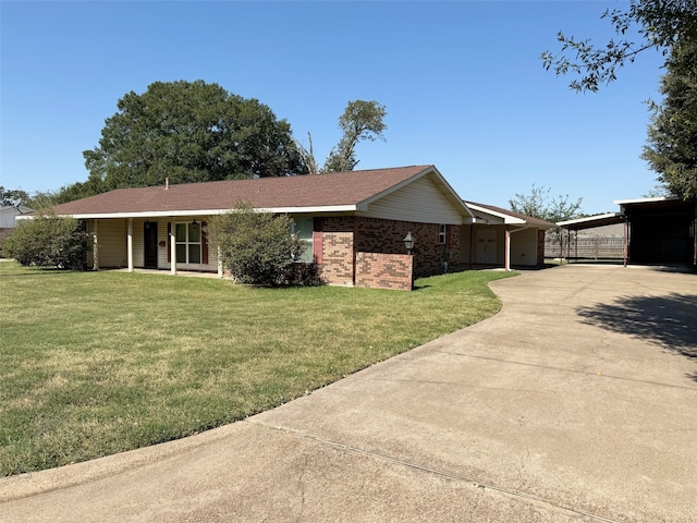 view of front of property with a front yard and a carport