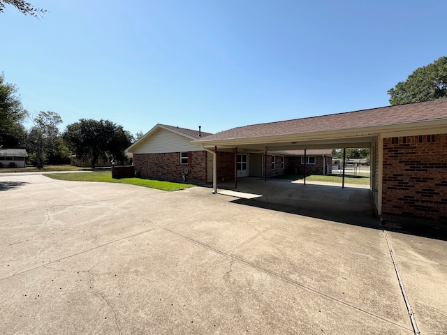 view of parking / parking lot featuring a carport