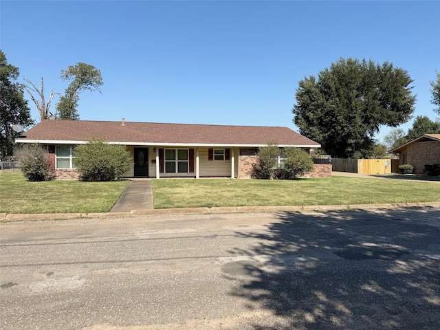 ranch-style house featuring a front lawn