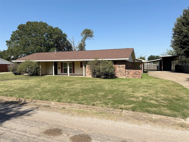 ranch-style home featuring a front lawn and a carport