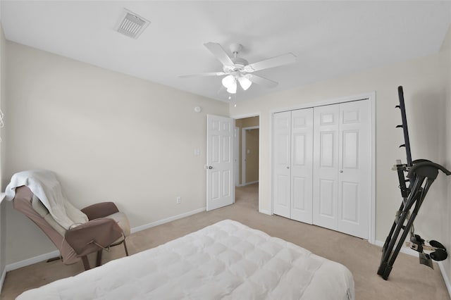 carpeted bedroom with a closet and ceiling fan