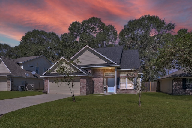 view of front facade with a garage and a lawn