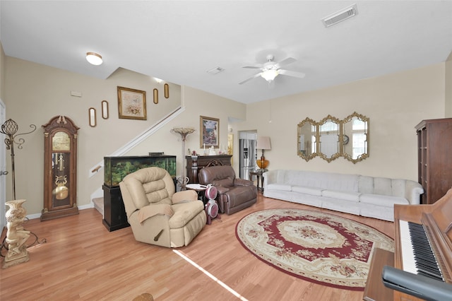 living room with ceiling fan and hardwood / wood-style flooring