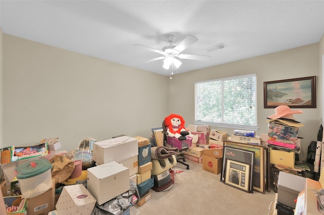 recreation room with ceiling fan and light carpet