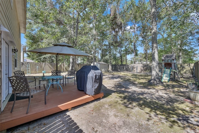 view of yard with a playground and a deck