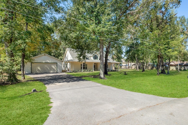 view of front of home featuring a garage, a front lawn, and covered porch