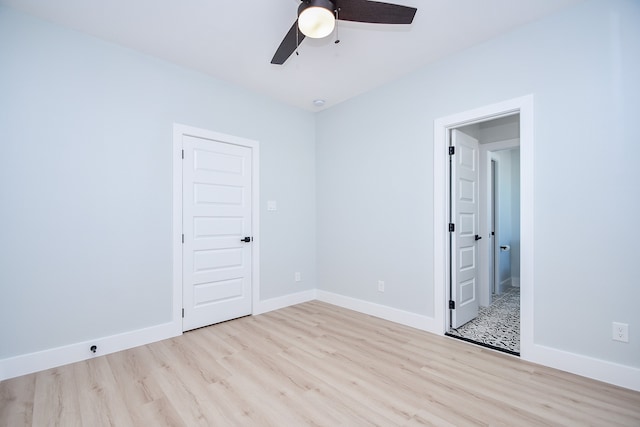 spare room with light wood-type flooring and ceiling fan