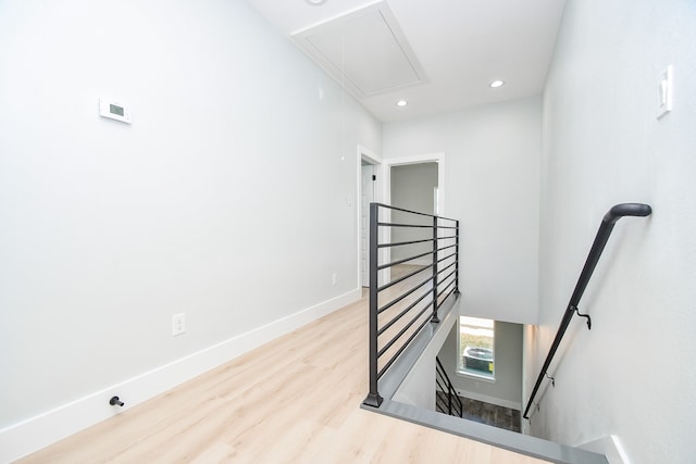 staircase with hardwood / wood-style floors