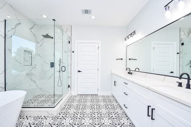 bathroom featuring vanity and shower with separate bathtub