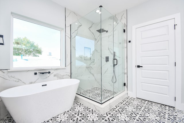 bathroom with plus walk in shower, tile walls, and tile patterned flooring