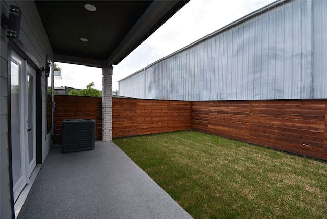 view of yard featuring central air condition unit and a patio