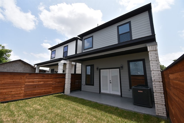 back of house with a patio, central air condition unit, and a lawn