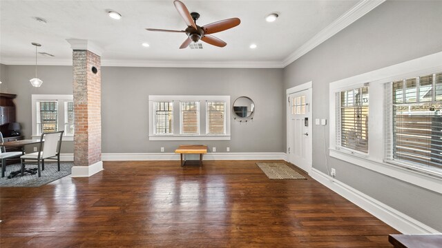 interior space with ornate columns, crown molding, and dark wood-type flooring